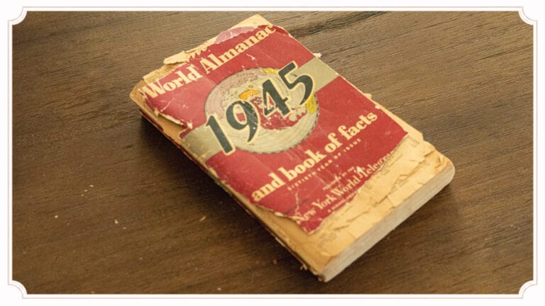 A vintage 1945 almanac resting on a handmade wooden table at The Cottage at Foxhavens.