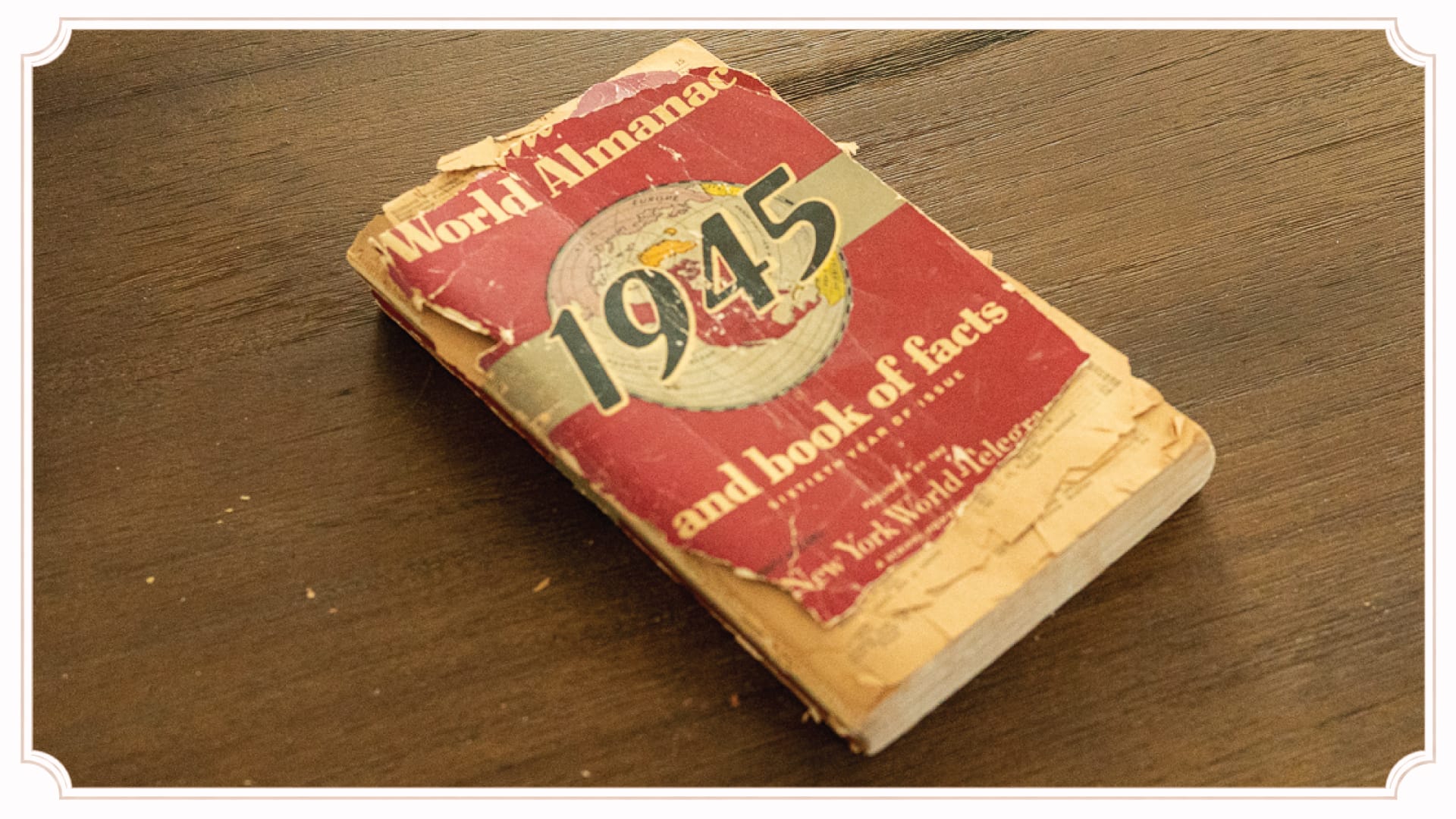 A vintage 1945 almanac resting on a handmade wooden table at The Cottage at Foxhavens.