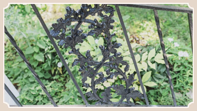 Oak leaf and acorn iron railing along the front steps of The Cottage at Foxhavens